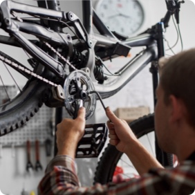 man working on bike chain