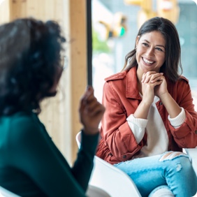 two women talking in coworking space